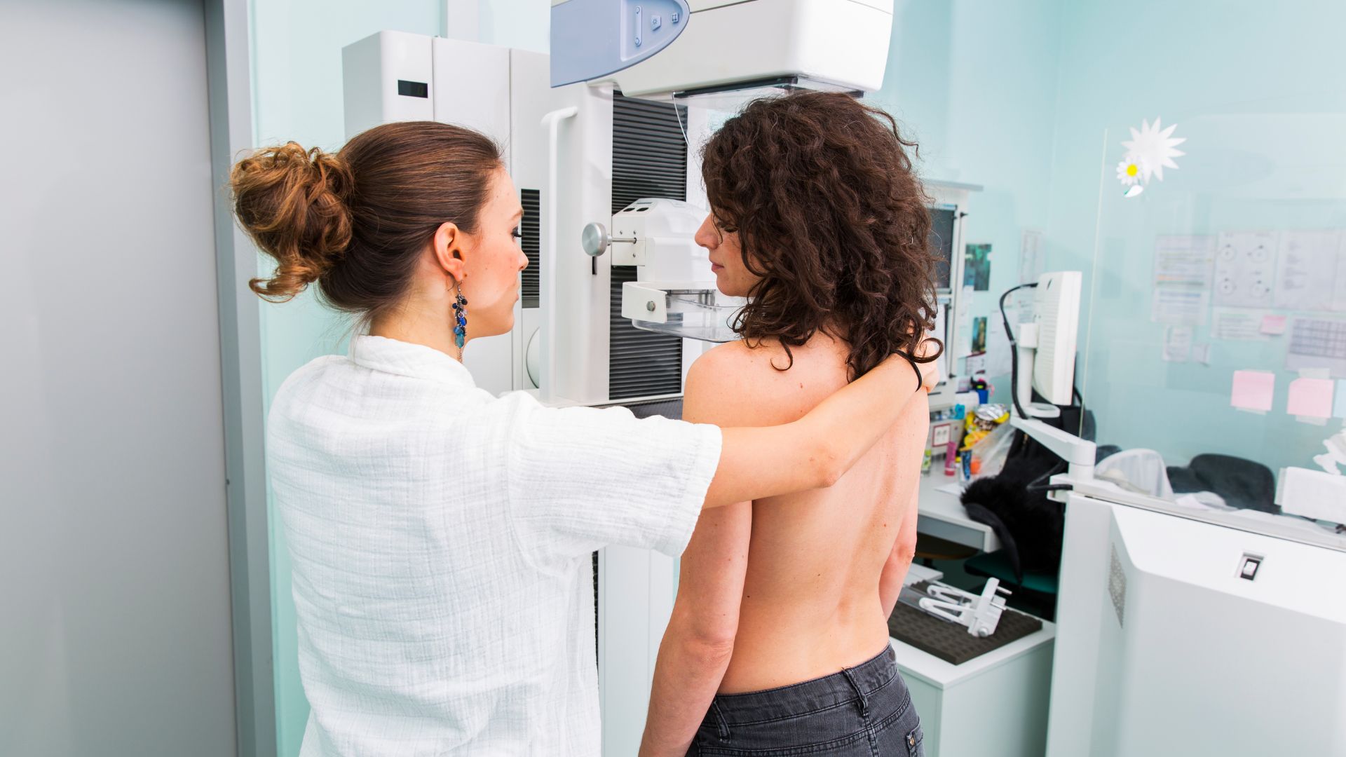 Woman getting a mammogram, with technologist